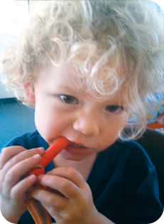 Client/child eating a carrot.