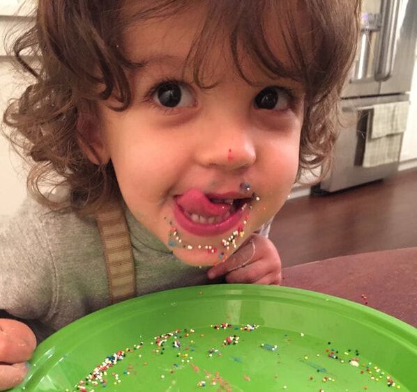 Client/child with sprinkles all over her face from feeding therapy
