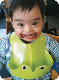 Client/child with a messy face and a bib after during feeding therapy